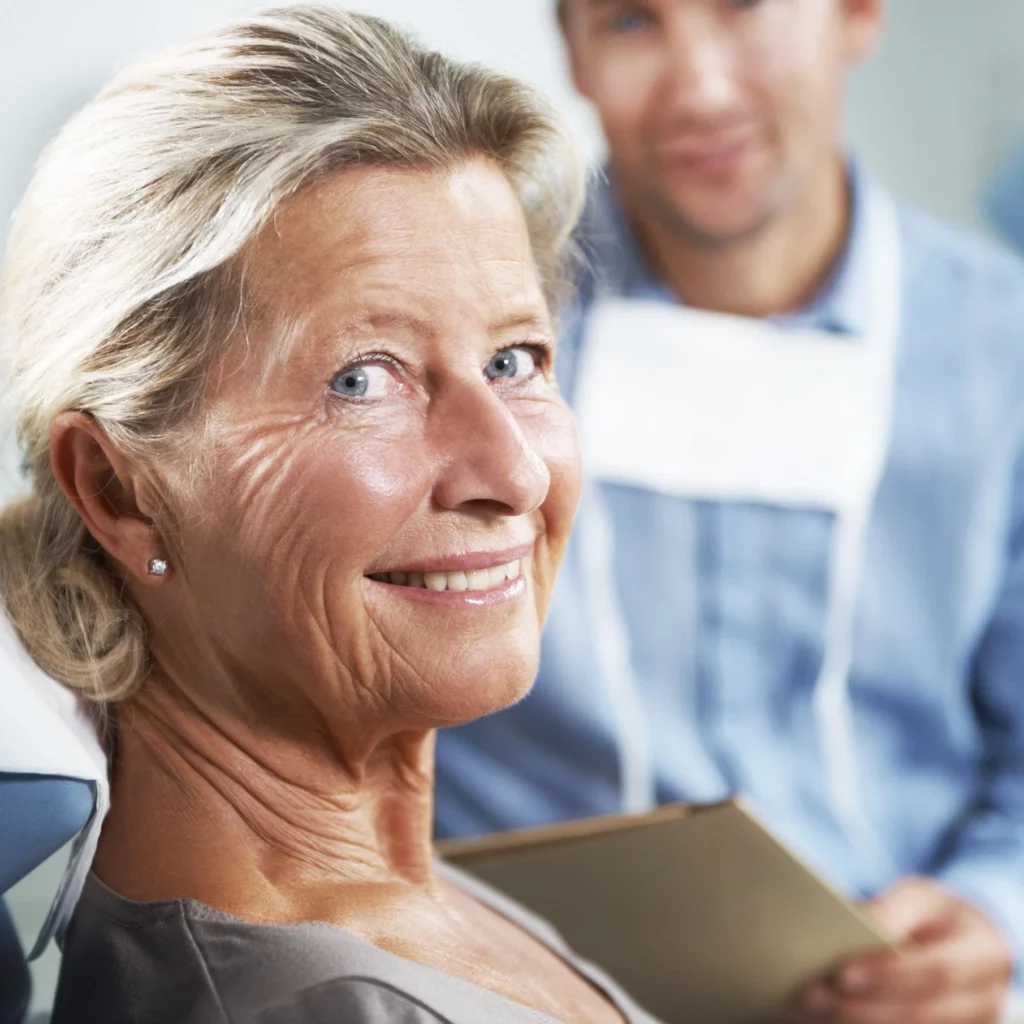 elderly woman smiling at dentist